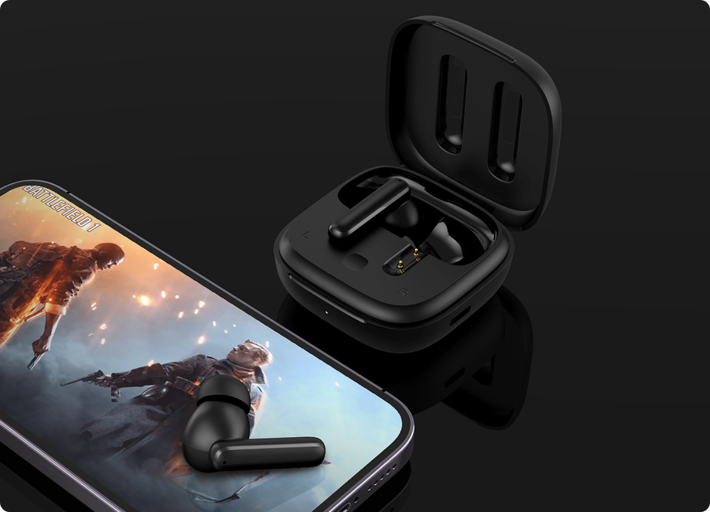 Czarne słuchawki Bluetooth z etui ładującym obok smartfona, na ekranie Battlefield 1.