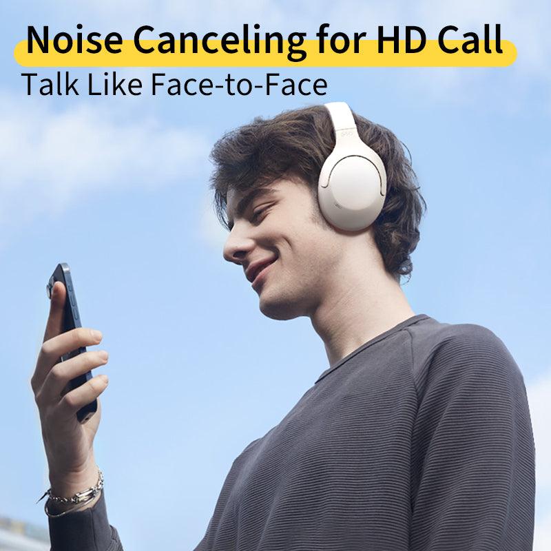 Black QCY H3 Lite headphones with noise canceling for HD calls, shown on model using phone outdoors.
